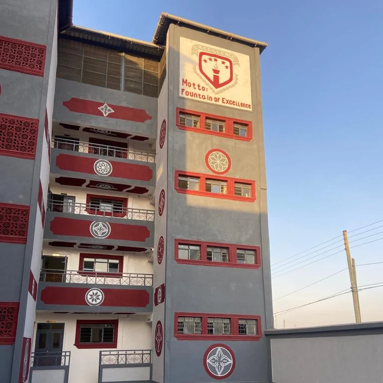 School building with Fountain of Excellence motto